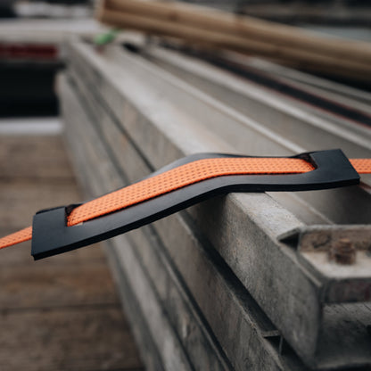 XL strap abrasion protector between orange webbing and a cargo edge